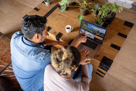A couple planning a vacation on a tourism website. 