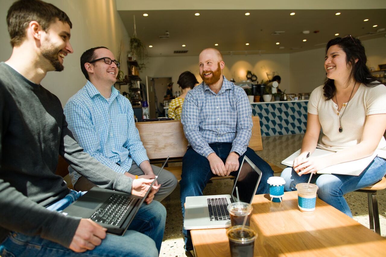 Lightburn team members in a meeting at a coffee shop. 