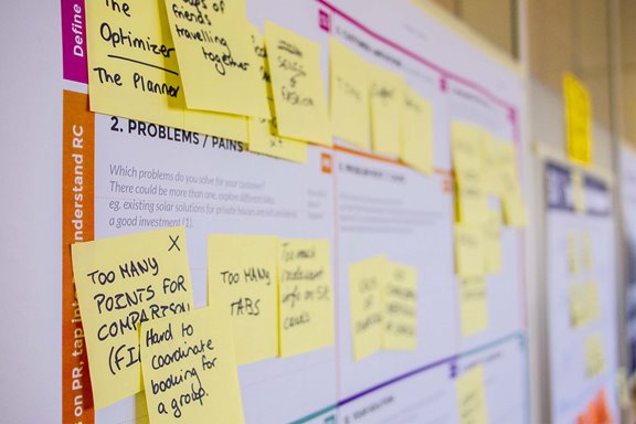 Sticky notes on large sheets of paper for strategic planning