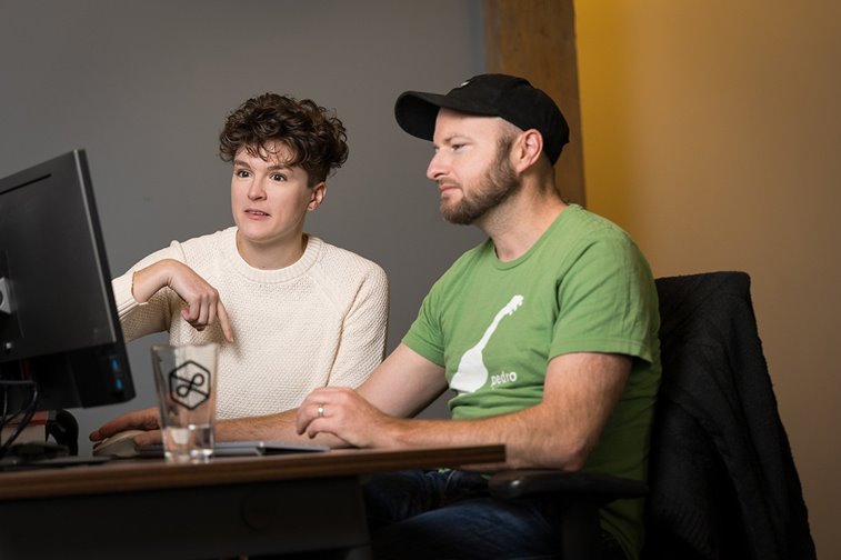 A man and a woman working together at a computer