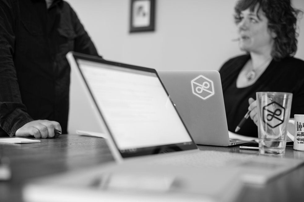 A close-up of a web development and strategy meeting at Lightburn in black-and-white. 