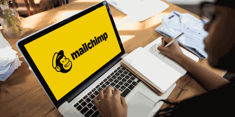 A bright yellow MailChimp logo page on a laptop screen