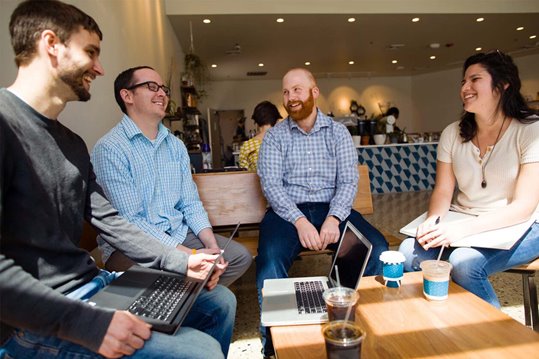 Web development team in a meeting at a coffee shop