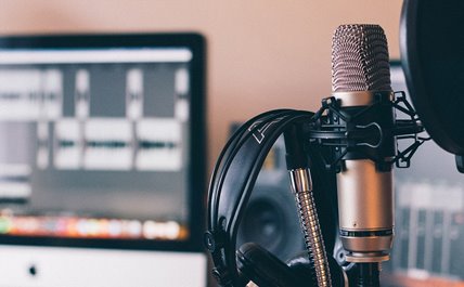 close up of headphone and microphone used for podcast production 