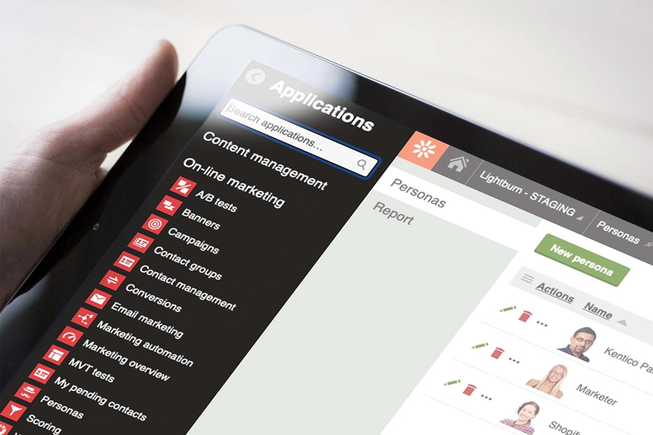 Close-up of the Kentico CMS interface on a screen someone is holding