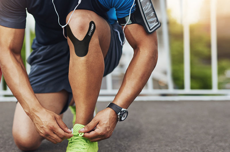 runner tying his neon shoe with a Rapidforce shape on his knee