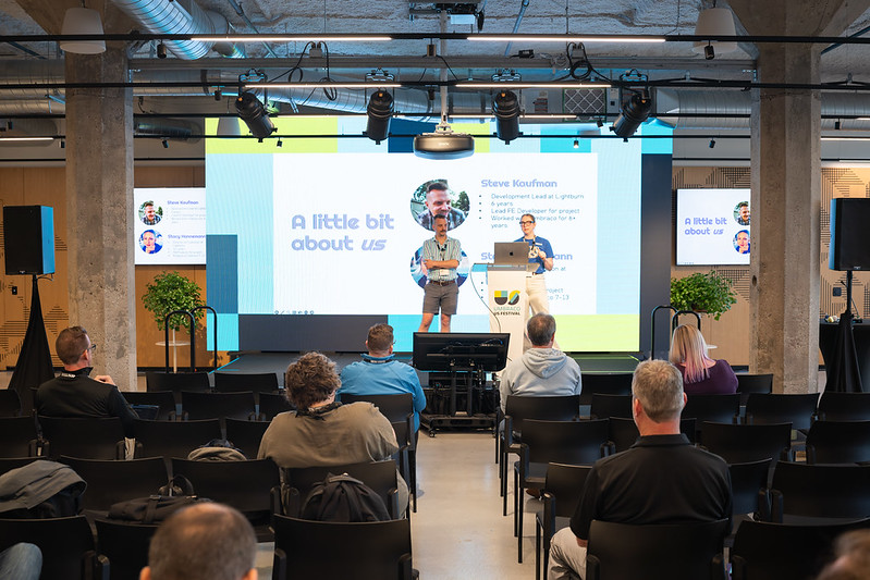 Two Lightburn team members, Steve and Stacy, standing on stage at the 2025 Umbraco US Festival. 